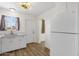 Cozy kitchen featuring white cabinets, stainless sink, and wood-look flooring at 1944 W Osborn Rd, Phoenix, AZ 85015