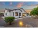 Expansive backyard with desert landscaping, covered patio, and ambient lighting creates an inviting outdoor oasis at 20165 E Via Del Palo Dr, Queen Creek, AZ 85142