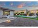 Inviting backyard with pool, lounge chairs, gravel landscaping, and ambient lighting at 20165 E Via Del Palo Dr, Queen Creek, AZ 85142