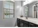 Bathroom features a single sink vanity, neutral walls, a window, and recessed lighting at 20165 E Via Del Palo Dr, Queen Creek, AZ 85142