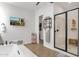 Stylish bathroom with a glass-enclosed shower, a deep soaking tub and modern fixtures at 20165 E Via Del Palo Dr, Queen Creek, AZ 85142