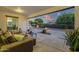 Inviting covered patio with plush seating overlooking a serene backyard landscape at 20165 E Via Del Palo Dr, Queen Creek, AZ 85142