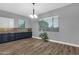 Bright dining area with wood floors, a modern chandelier, and view from two windows at 20165 E Via Del Palo Dr, Queen Creek, AZ 85142
