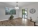 Bright dining room with lots of natural light, neutral walls, and wood-look floors at 20165 E Via Del Palo Dr, Queen Creek, AZ 85142