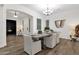 Open-concept dining room featuring wood floors, neutral walls, modern chandelier and a view into the entryway at 20165 E Via Del Palo Dr, Queen Creek, AZ 85142