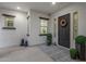 Inviting entryway showcasing a decorative door, pot plants, statuettes and neutral finishes at 20165 E Via Del Palo Dr, Queen Creek, AZ 85142