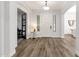 Bright entryway featuring wood floors, white walls, paneled door, and a view into adjacent rooms at 20165 E Via Del Palo Dr, Queen Creek, AZ 85142