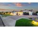 Beautiful single-story home featuring stone accents, lush lawn, manicured landscaping, and a two-car garage at 20165 E Via Del Palo Dr, Queen Creek, AZ 85142