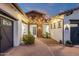 Inviting home exterior showcasing a brick walkway, decorative lighting, manicured shrubs, and a welcoming entrance at 20165 E Via Del Palo Dr, Queen Creek, AZ 85142