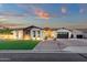 Charming single-story home featuring stone accents, lush lawn, manicured landscaping, and a two-car garage at 20165 E Via Del Palo Dr, Queen Creek, AZ 85142
