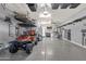 Organized garage space with epoxy flooring, storage racks, and a golf cart at 20165 E Via Del Palo Dr, Queen Creek, AZ 85142