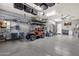 Spacious garage featuring epoxy floors, storage shelves, and a golf cart at 20165 E Via Del Palo Dr, Queen Creek, AZ 85142