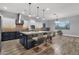 This kitchen features a large island with seating and modern stainless steel appliances at 20165 E Via Del Palo Dr, Queen Creek, AZ 85142