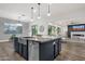 A spacious kitchen island with granite countertop and stainless steel appliances is featured at 20165 E Via Del Palo Dr, Queen Creek, AZ 85142
