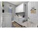 Laundry room with cabinetry, counter space, front load washer/dryer, and decor at 20165 E Via Del Palo Dr, Queen Creek, AZ 85142