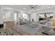This living room features a modern ceiling fan and seamlessly flows into the kitchen at 20165 E Via Del Palo Dr, Queen Creek, AZ 85142