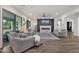 Comfortable living room featuring a fireplace with a TV, light-colored furniture, and a ceiling fan at 20165 E Via Del Palo Dr, Queen Creek, AZ 85142