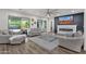 Comfortable living room featuring a fireplace with a TV, light-colored furniture, and a ceiling fan at 20165 E Via Del Palo Dr, Queen Creek, AZ 85142