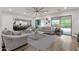 Spacious living room with light-colored furniture, a ceiling fan, and sliding door access to the backyard at 20165 E Via Del Palo Dr, Queen Creek, AZ 85142