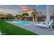 Relaxing pool area with lounge chairs, manicured lawn, and a tranquil ambiance at 20165 E Via Del Palo Dr, Queen Creek, AZ 85142