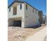 Two-story home under construction with a two-car garage and tan stucco exterior, next to a sidewalk at 2469 W Rowel Rd, Phoenix, AZ 85085