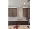 Kitchen with white backsplash, white countertop, brown cabinets, and stainless steel appliances ready for installation at 2469 W Rowel Rd, Phoenix, AZ 85085