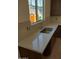 Kitchen sink with white countertop, a silver faucet, and a large window, offering a view of the neighborhood at 2469 W Rowel Rd, Phoenix, AZ 85085