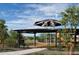 Community playground featuring shade structures, climbing frames, and play equipment at 2469 W Rowel Rd, Phoenix, AZ 85085