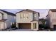 Charming two-story home with a two car garage and landscaped front yard at twilight at 2476 W Rowel Rd, Phoenix, AZ 85085