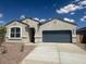 Charming single-story home featuring a two-car garage and a well-maintained front yard at 25283 N 183Rd Dr, Wittmann, AZ 85361
