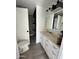 Bathroom with shower, white vanity, large mirror and updated lighting at 2853 W Ohio St, Apache Junction, AZ 85120