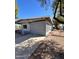 Garage with gray paint, a driveway and gated yard at 2853 W Ohio St, Apache Junction, AZ 85120