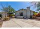 The backyard showcases a spacious concrete patio, a covered outdoor kitchen, and direct access to the home's rear entrance at 3201 W Evans Dr, Phoenix, AZ 85053