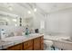 Bathroom featuring double sinks, tub and shower at 3201 W Evans Dr, Phoenix, AZ 85053
