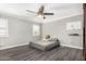 Bedroom features wood-look flooring, ceiling fan, and gray painted walls at 3201 W Evans Dr, Phoenix, AZ 85053