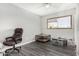 Bedroom featuring wood-look flooring, window and chair at 3201 W Evans Dr, Phoenix, AZ 85053