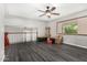 Upstairs bonus room with dark floors, neutral walls, a ceiling fan, and natural light from the window at 3201 W Evans Dr, Phoenix, AZ 85053
