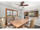 Dining area features a rustic table, wooden chairs, and a view into the connected kitchen space at 3201 W Evans Dr, Phoenix, AZ 85053