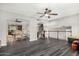 Open-concept living area with dark laminate floors, a staircase, and views of the kitchen and dining room at 3201 W Evans Dr, Phoenix, AZ 85053