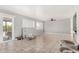Open living room with neutral paint, tiled floors, a sliding glass door, and an adjacent dining area at 3201 W Evans Dr, Phoenix, AZ 85053