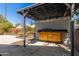 View of the outdoor kitchen featuring a sink, wooden cabinets, and countertop space, all within a covered area at 3201 W Evans Dr, Phoenix, AZ 85053