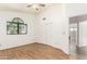 A bright bedroom with wood floors, a large window, and ensuite bathroom access at 3761 W Kent Dr, Chandler, AZ 85226