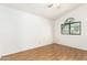 A bright bedroom with wood floors and a large window at 3761 W Kent Dr, Chandler, AZ 85226