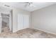 Neutral-toned bedroom with double closet doors and tile flooring; a blank canvas for personal style at 3761 W Kent Dr, Chandler, AZ 85226