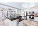Bright kitchen featuring stainless steel appliances, granite countertops, and a breakfast bar with views of the backyard at 3761 W Kent Dr, Chandler, AZ 85226