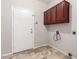 A practical laundry room with ample cabinets and tiled floors at 3761 W Kent Dr, Chandler, AZ 85226