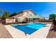 Backyard featuring sparkling pool, spa, shade sail, and privacy landscaping at 3761 W Kent Dr, Chandler, AZ 85226