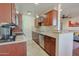 Well-lit kitchen with wood cabinetry, granite countertops, and modern appliances at 4120 N 78Th St # 201, Scottsdale, AZ 85251