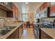 Functional kitchen featuring tiled backsplash, wood cabinets, and granite countertops at 4120 N 78Th St # 201, Scottsdale, AZ 85251