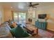 Bright living room showcasing a sliding glass door, hardwood floors, and cozy decor at 4120 N 78Th St # 201, Scottsdale, AZ 85251
